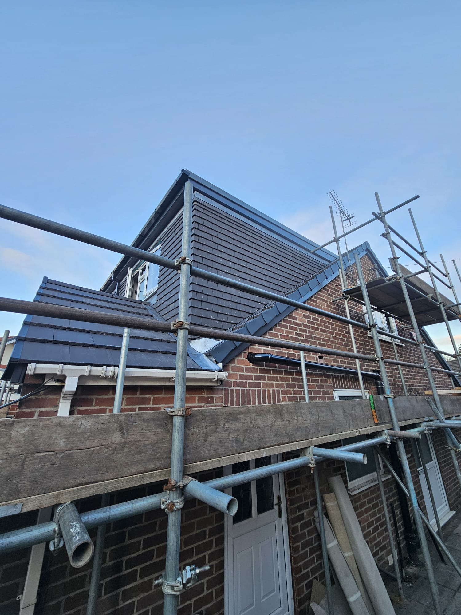 Brick house extension with scaffolding during a Leeds build