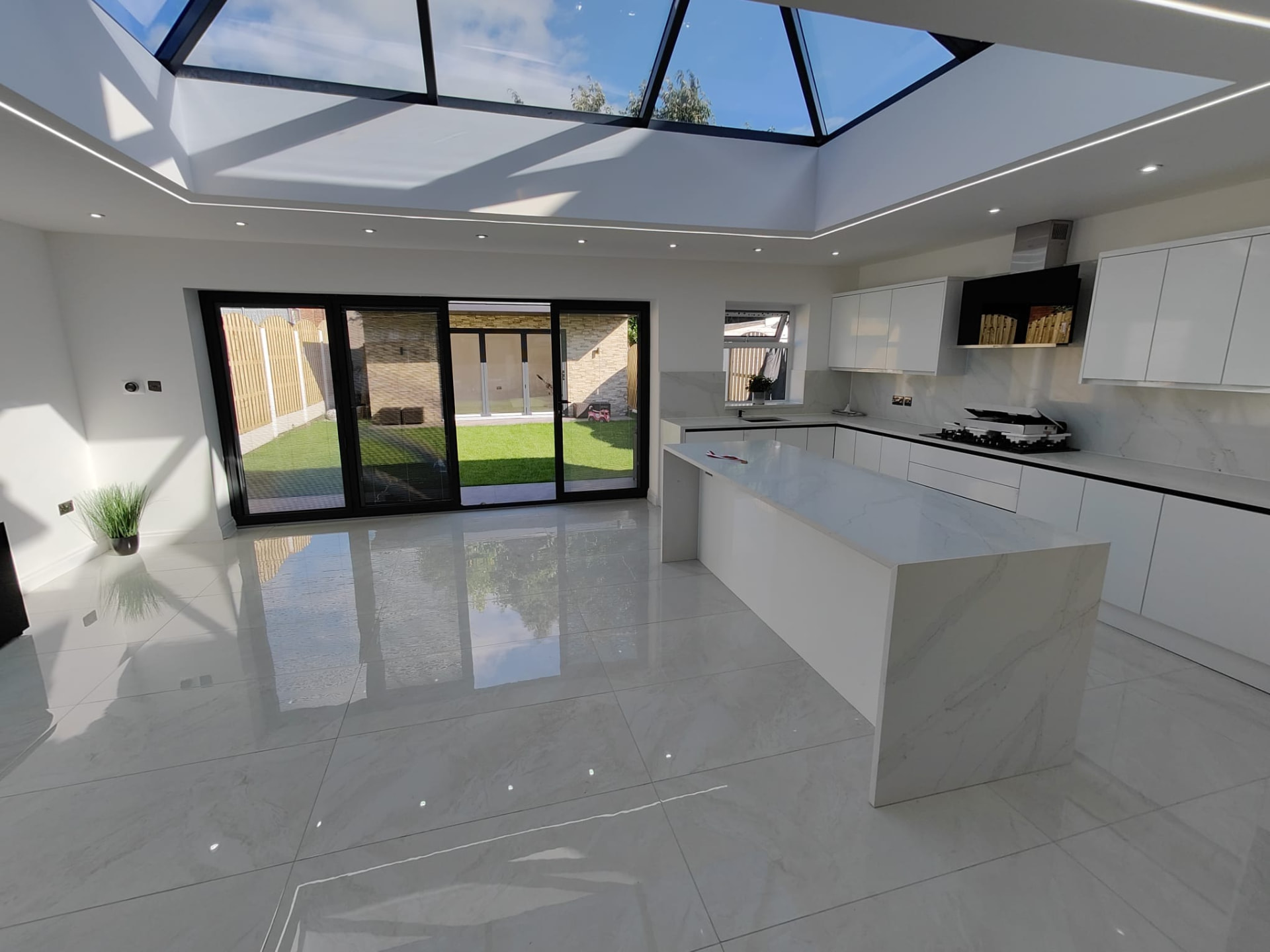 Modern kitchen extension interior with large glass roof lantern, Leeds