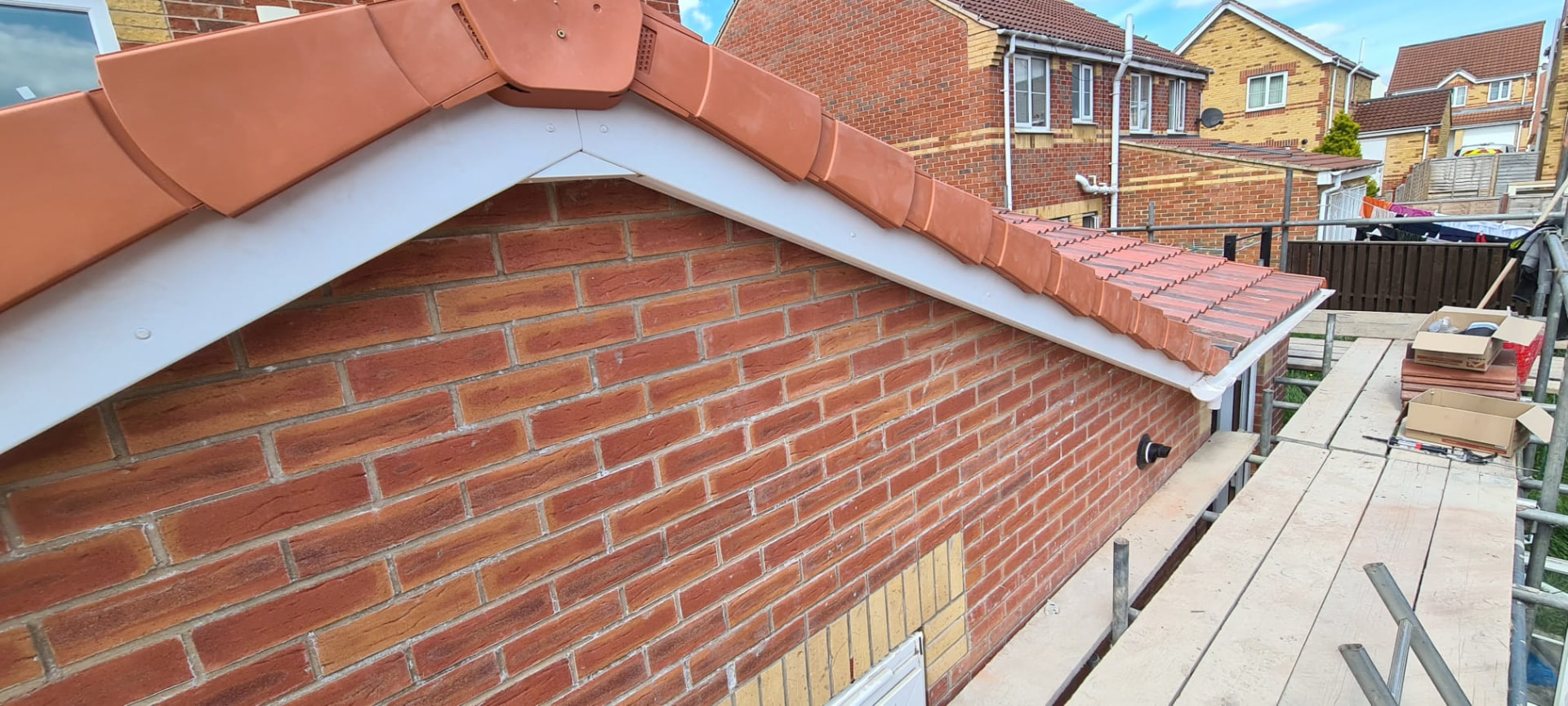 Finished terracotta tile roof with white fascia and gable detail, Leeds roofing