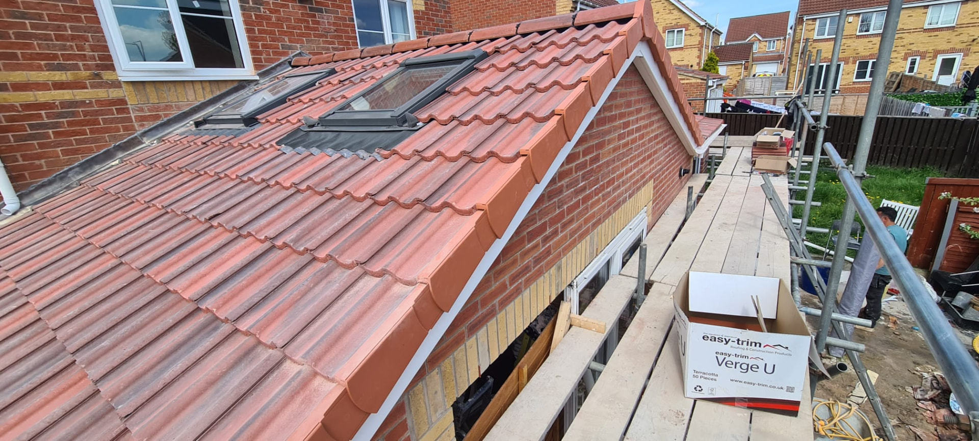 Terracotta roof tiles being laid on a Leeds extension with skylights installed