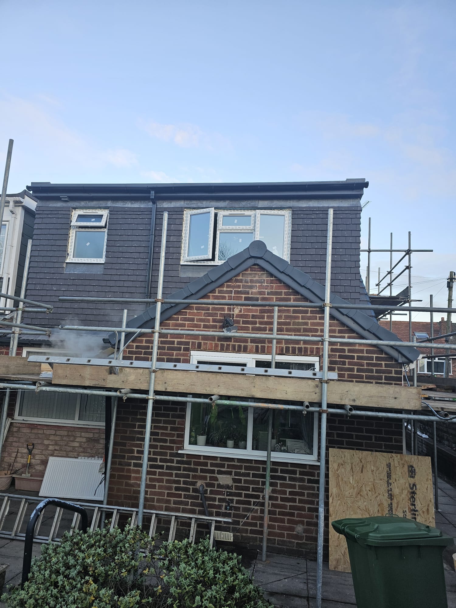 Dark slate dormer roof on a Leeds loft conversion, finished with scaffolding still in place