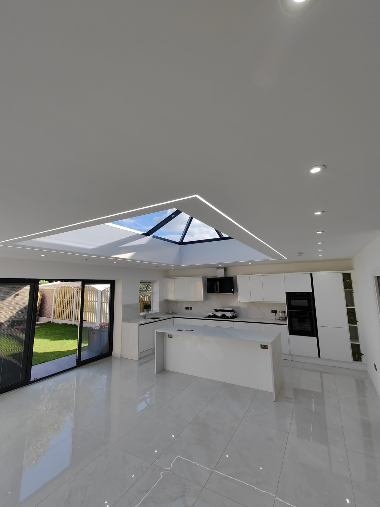 Finished open-plan kitchen extension with pyramid roof lantern, Leeds