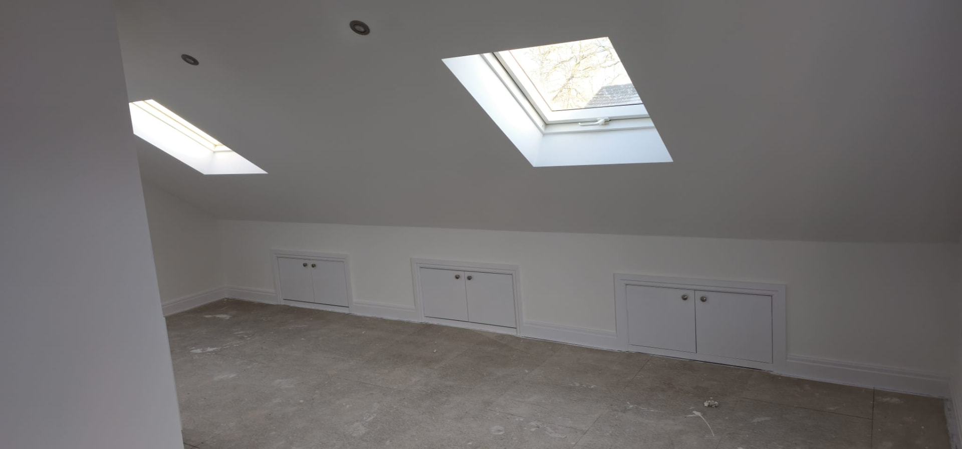 Finished loft attic room with white walls and skylights, Leeds loft conversion