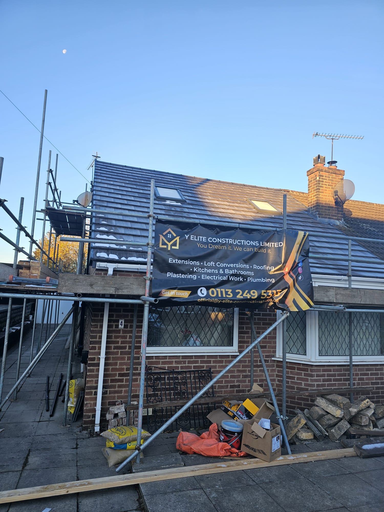 Leeds home under construction with scaffolding and Y Elite Constructions banner