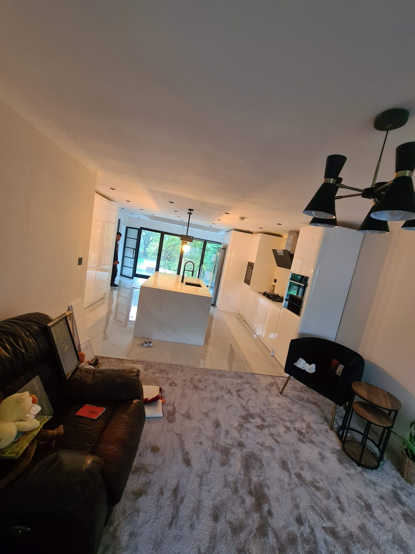 Open-plan kitchen and living area with modern white units, Leeds kitchen renovation