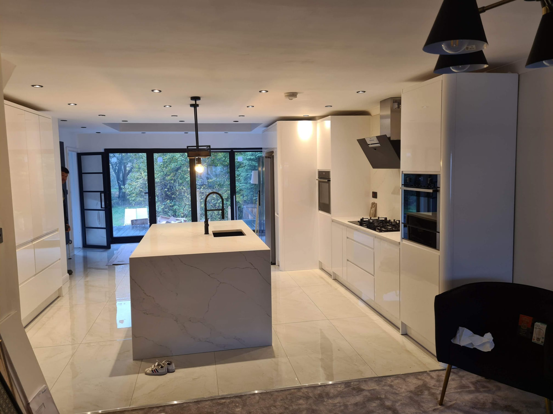 Finished open-plan kitchen diner in Leeds with quartz island and garden doors