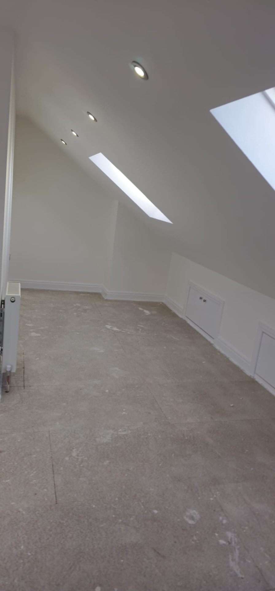 Finished loft conversion bedroom with skylights and radiator, Leeds