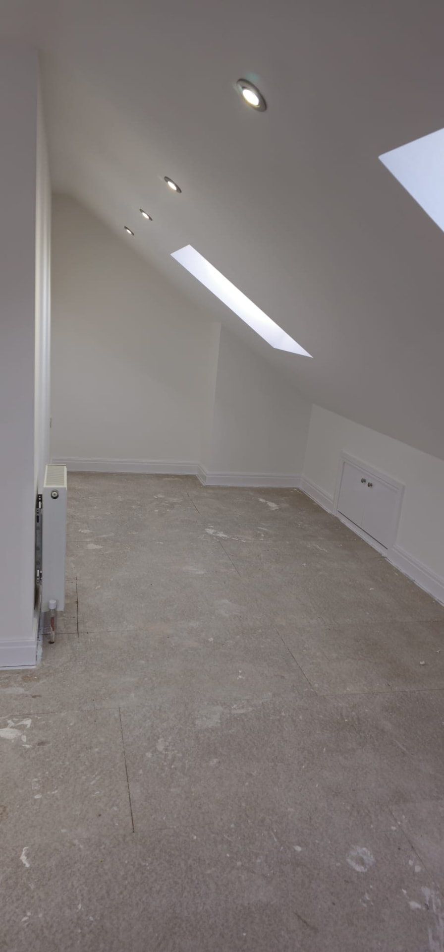Bright finished loft room with skylights after conversion, Leeds