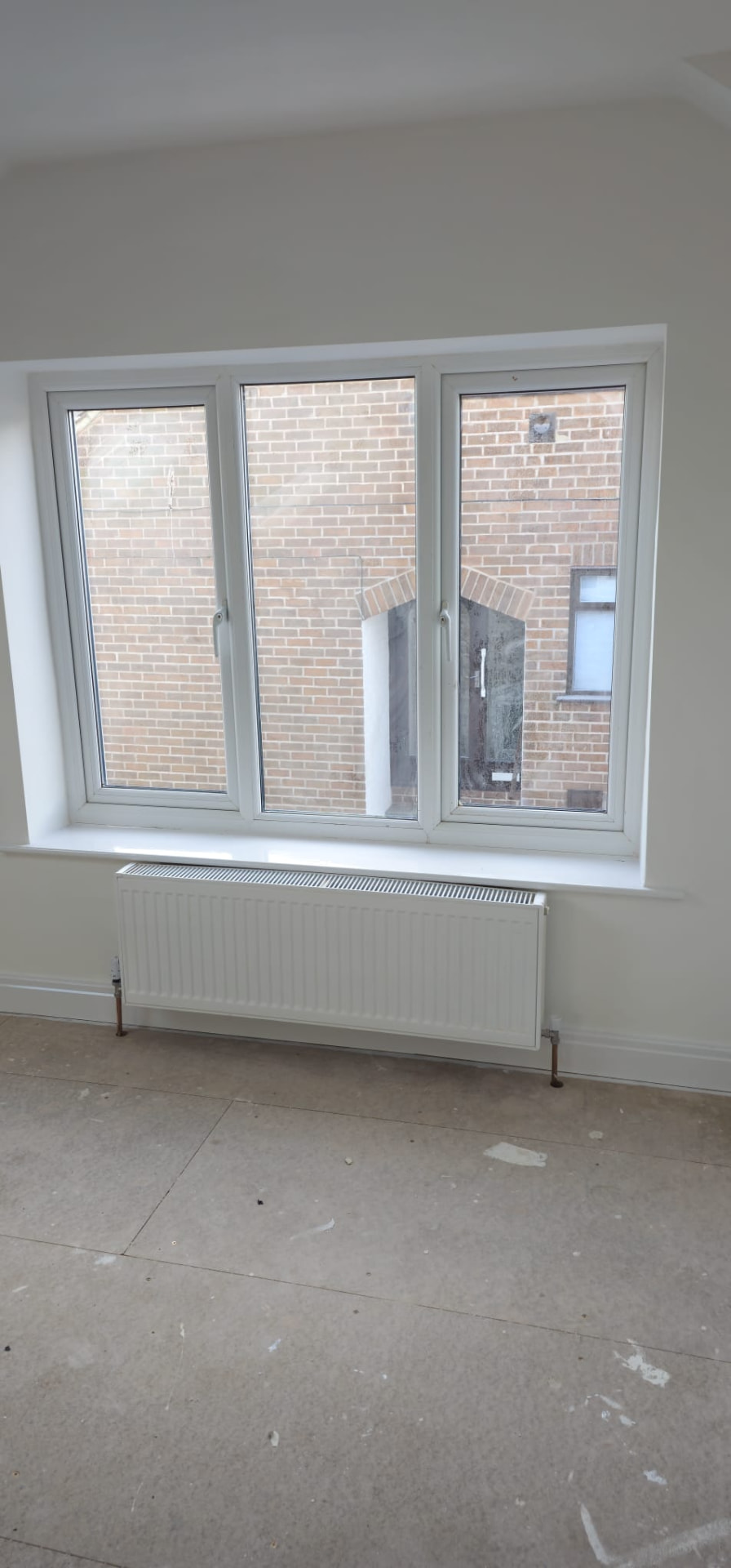 Bright interior of a finished home extension in Leeds, freshly plastered and painted