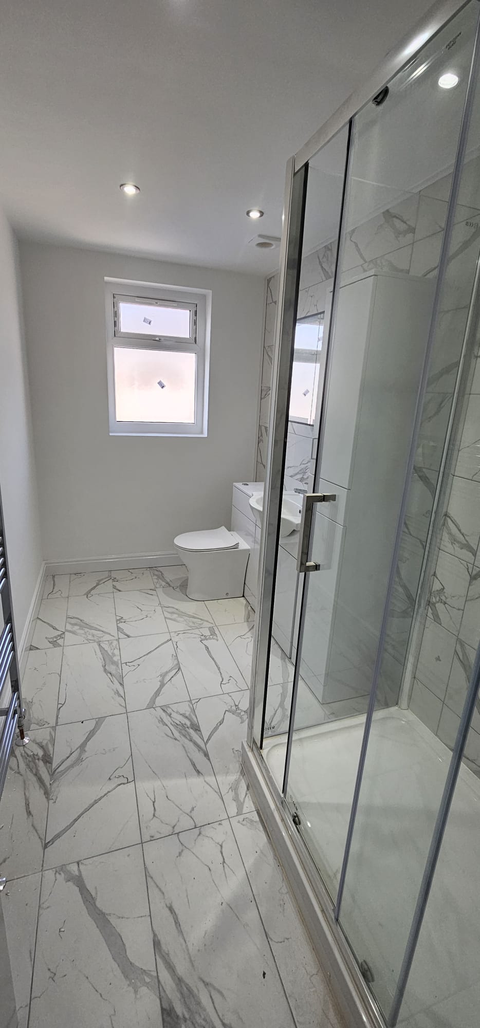 Marble-tiled walk-in shower area with tiled floor, Leeds bathroom renovation