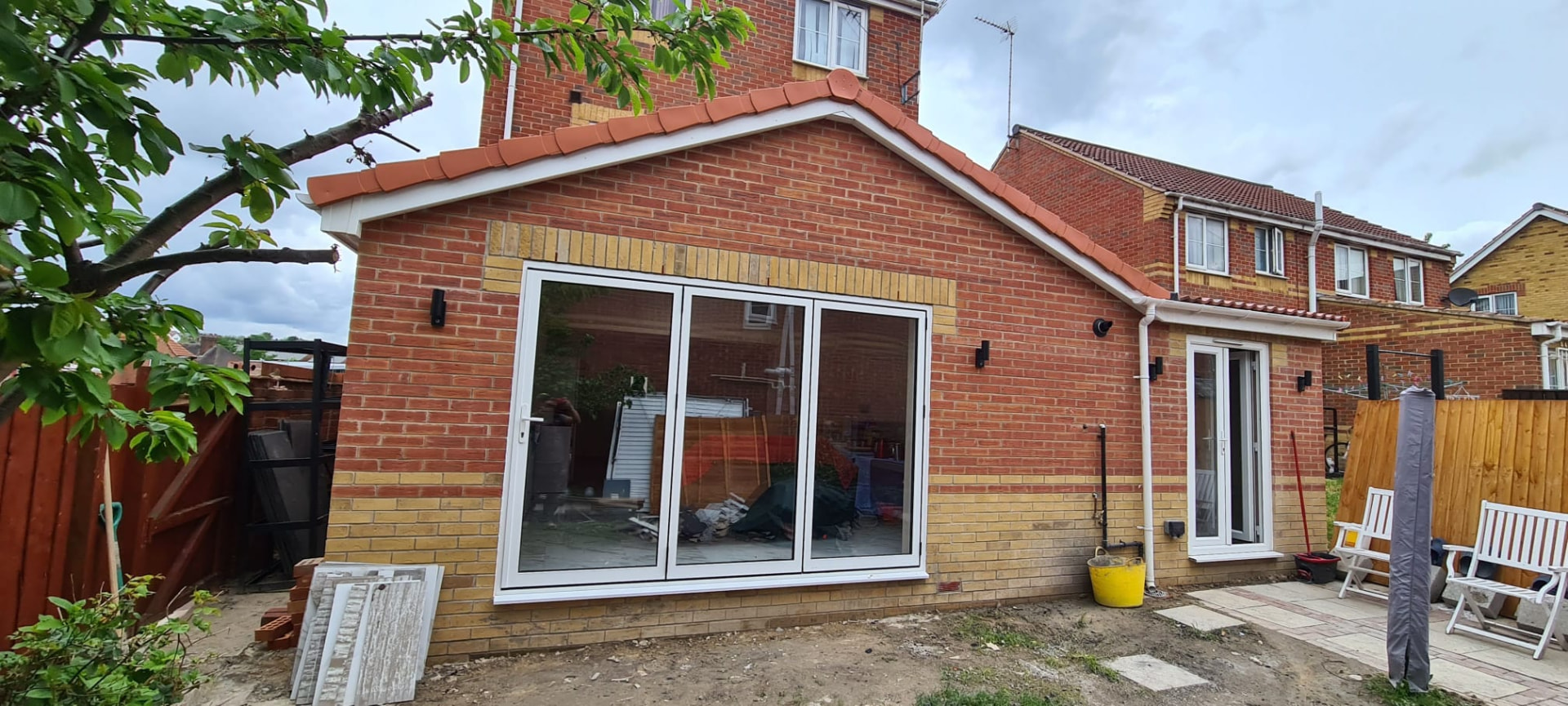 Completed single-storey rear extension in Leeds with pitched tiled roof and bi-fold doors
